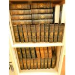 A group of leather bound Encyclopedia Britannica 9th Edition volumes. (2 shelves, AF)