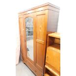 An Edwardian mahogany and inlaid wardrobe, the top with a moulded cornice above a mirrored door, wit