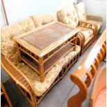 A cane conservatory suite, comprising two seater sofa, two arm chairs, and a coffee table. The uphol