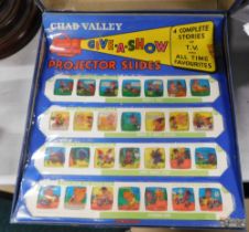 A cased set of Chad Valley projector slides, boxed.