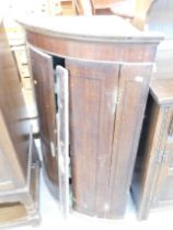 A George III oak and mahogany corner cupboard. (AF)