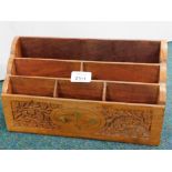 An Eastern hardwood magazine rack, with carved floral decoration and brass spade inlay.