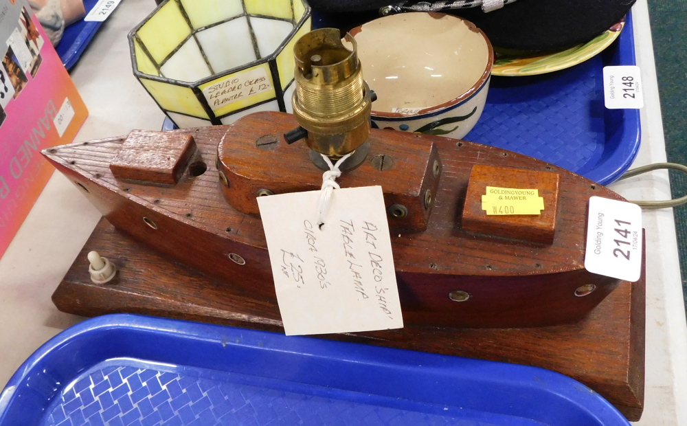 An Art Deco wooden table lamp, formed as a boat, 18cm high, 29cm wide, 10cm deep.