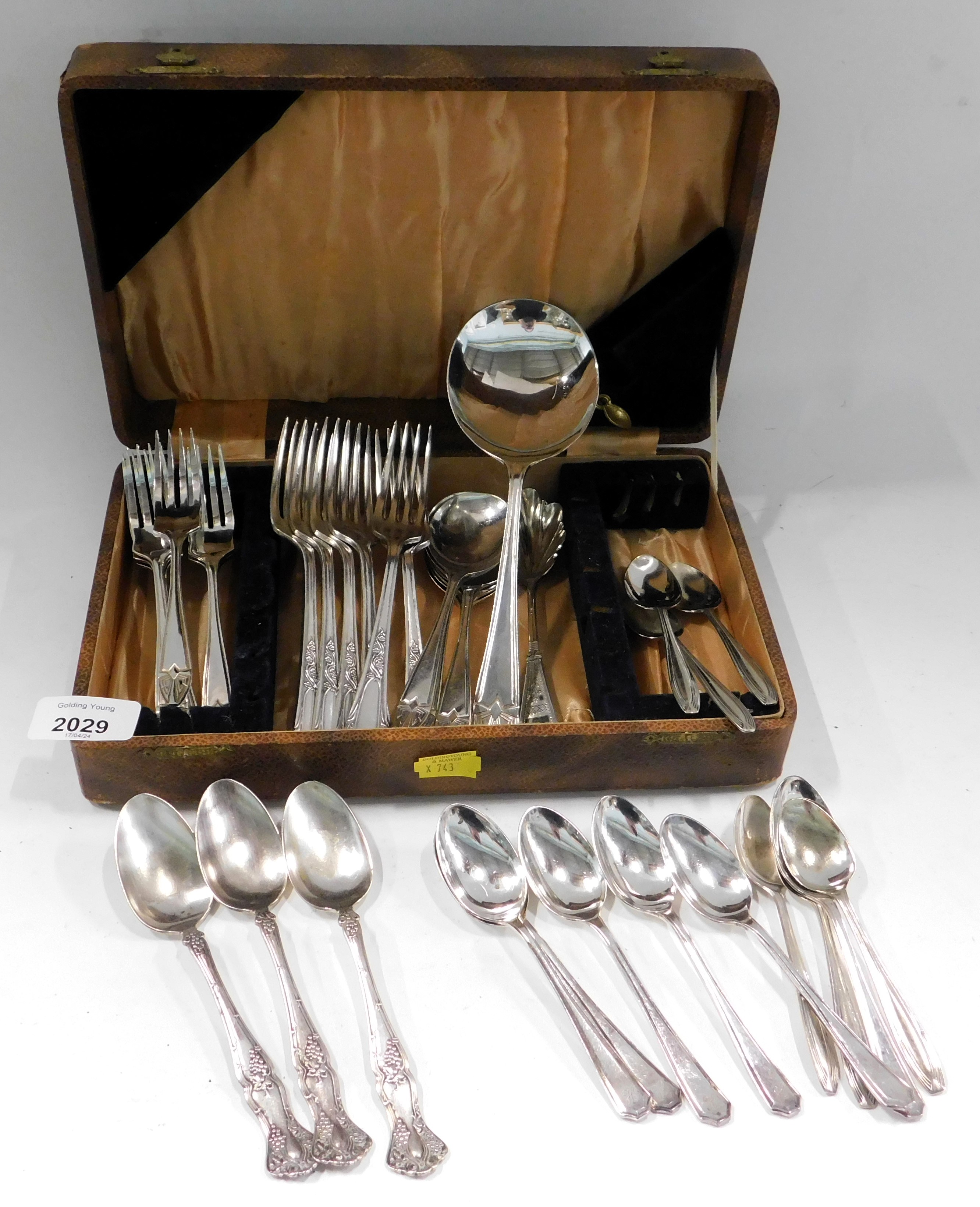 A group of silver plated cutlery.