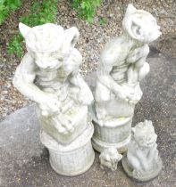 A pair of reconstituted stone goblin figures, 70cm high, and two other mythical beast figures, 29cm