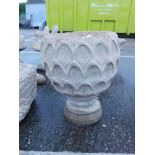 A reconstituted stone pineapple urn deep planter, pineapple pattern, on a circular base, 47cm high.