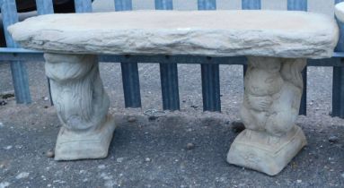 A reconstituted stone squirrel garden bench, on two classical scroll plinths with a curved seat, 41c