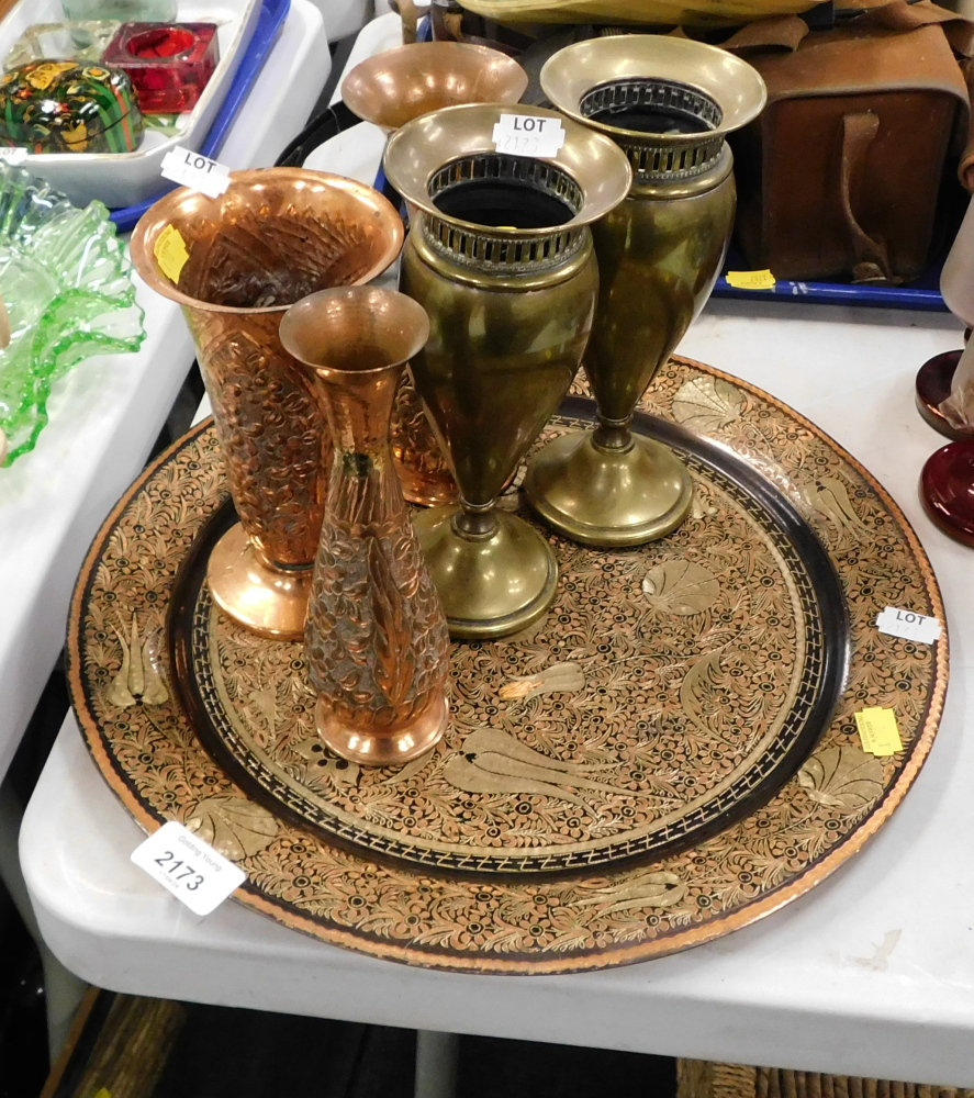 An Eastern detailed charger, together with copper and brass petalled vases.