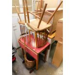 A melamine topped drop leaf kitchen table, two chairs, two stools, and a wheeled log basket.