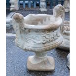 A reconstituted stone two handled urn planter, in the Neoclassical style, on a circular foot, 50cm h