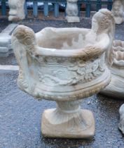 A reconstituted stone two handled urn planter, in the Neoclassical style, on a circular foot, 50cm h