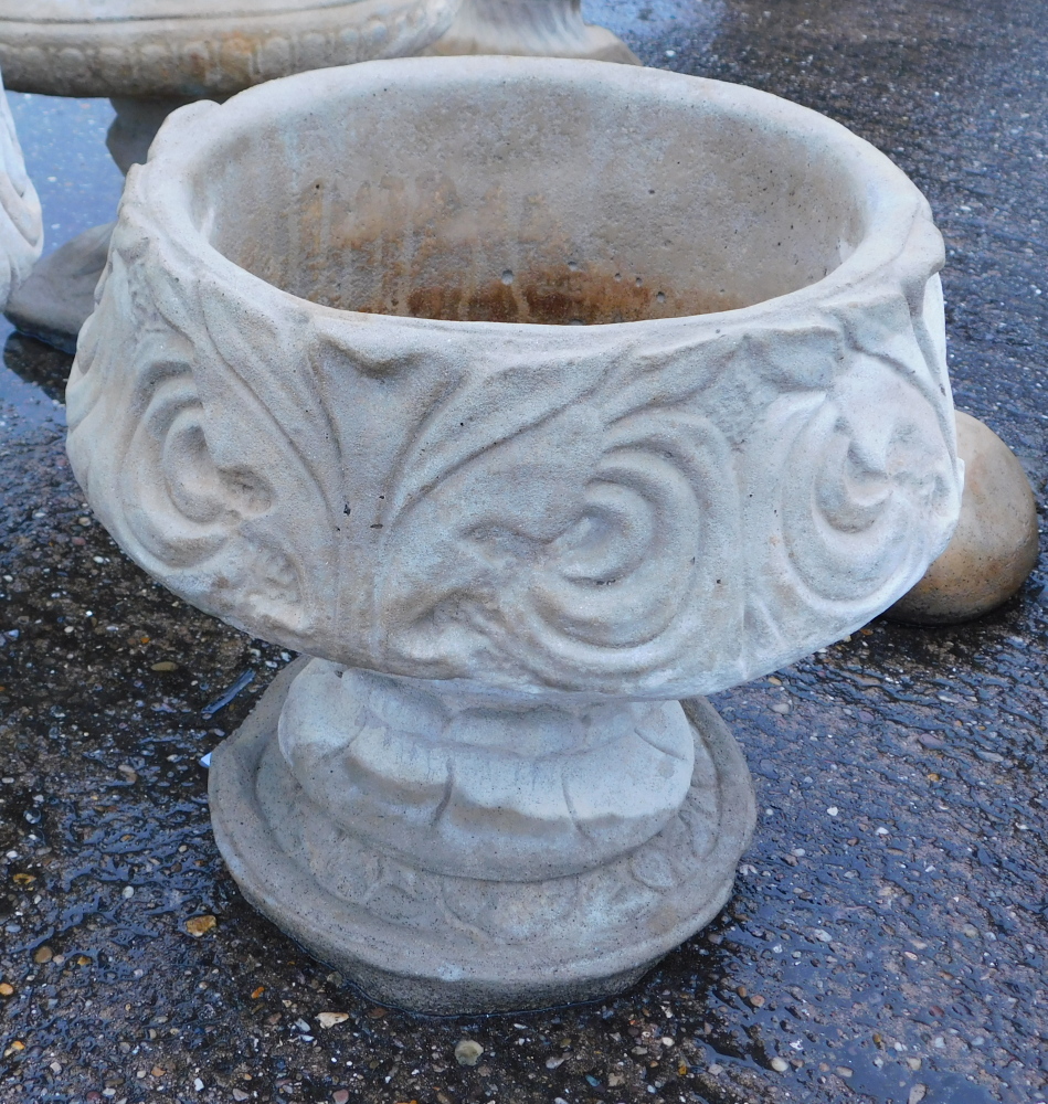 A reconstituted stone acanthus leaf garden urn, with a fluted border and shell Neoclassical scroll d