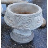 A reconstituted stone acanthus leaf garden urn, with a fluted border and shell Neoclassical scroll d