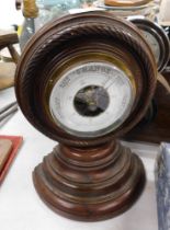 A 20thC oak cased barometer, with white enamel dial, on rope twist border, 26cm high.