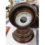 A 20thC oak cased barometer, with white enamel dial, on rope twist border, 26cm high.