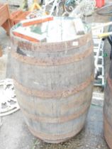 A coopered wooden barrel, 90cm high, 55cm diameter.