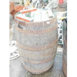 A coopered wooden barrel, 90cm high, 55cm diameter.