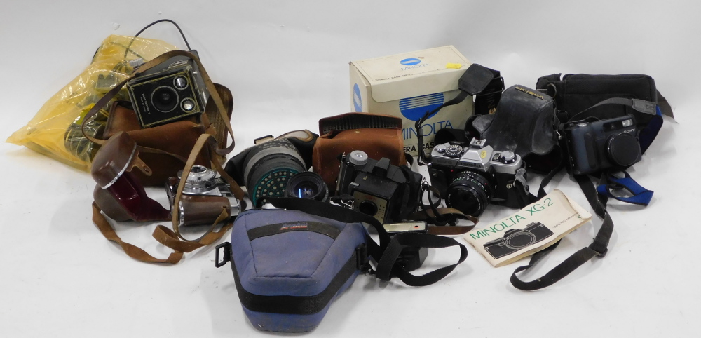 Various camera equipment, comprising a Minolta camera model XG-2 with case CH2, Kodak box brownie ca
