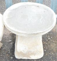 A reconstituted stone saddle stone, 36cm high.