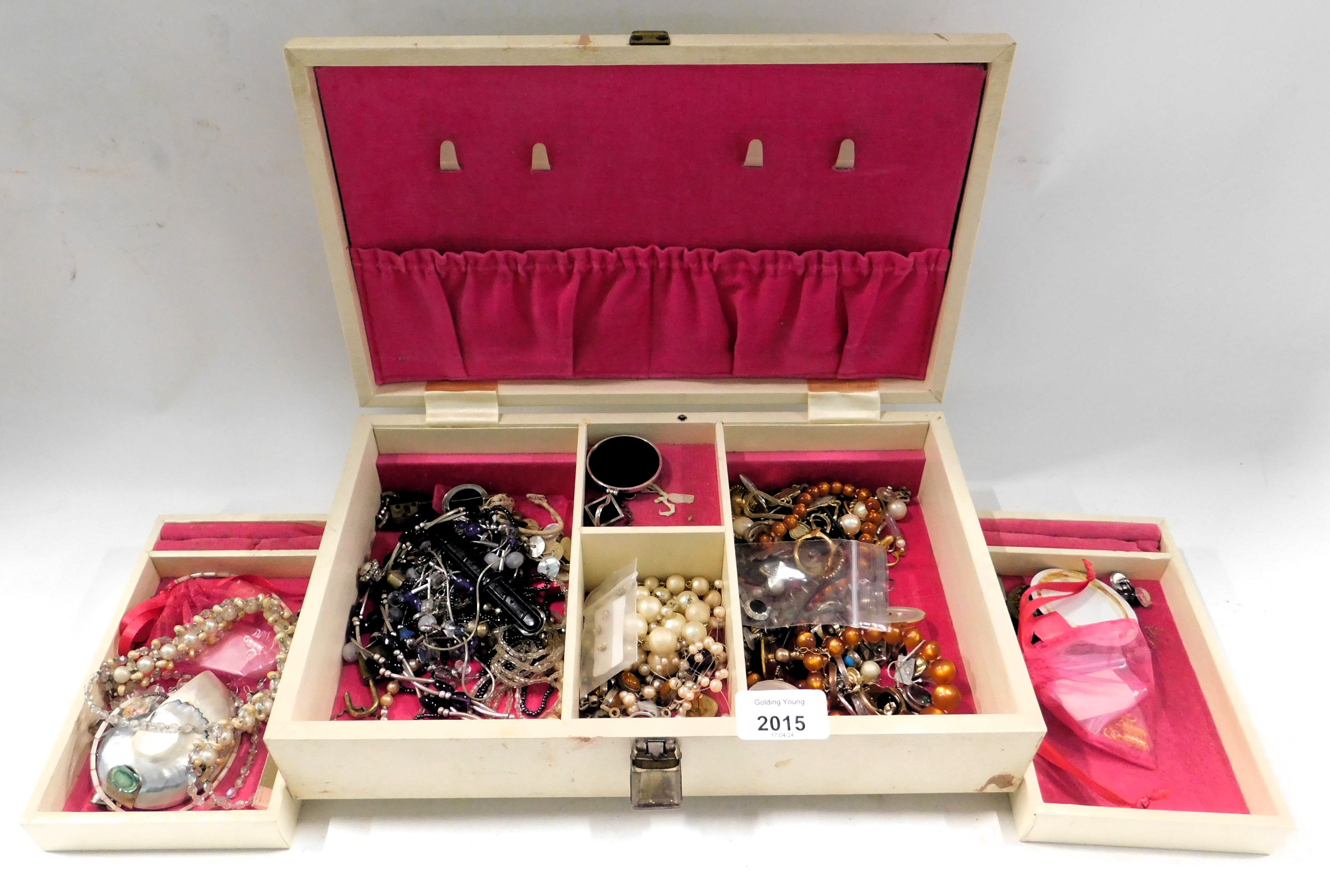 A cream leatherette jewellery box and contents of costume jewellery, comprising dress rings, butterf