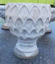 A reconstituted stone pineapple urn deep planter, pineapple pattern, on a circular base, 47cm high.