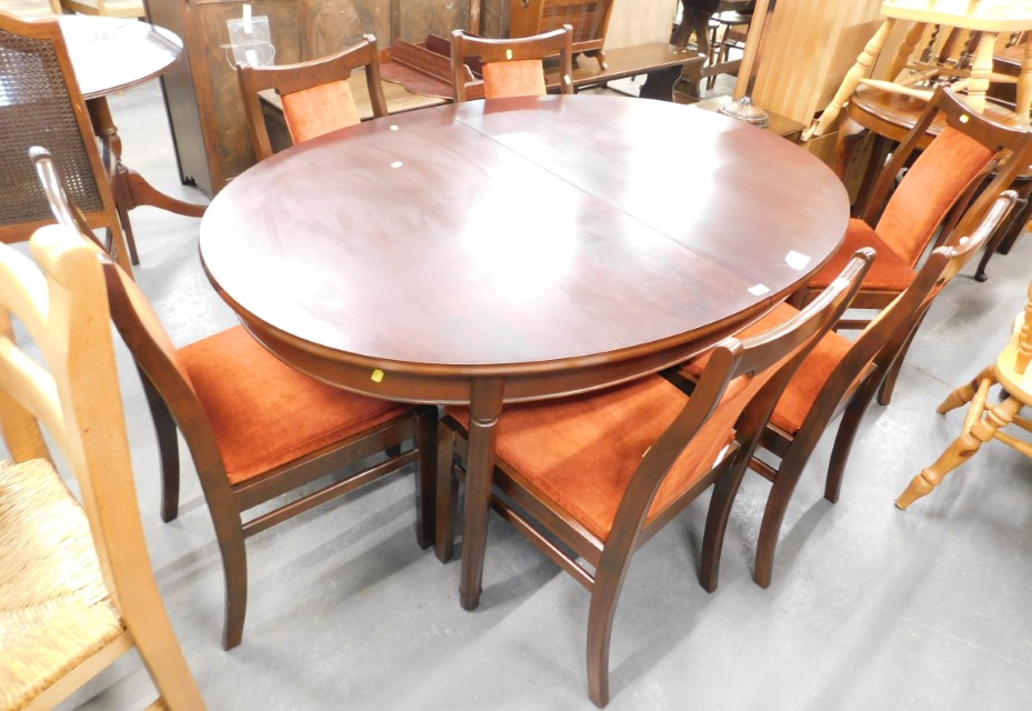 A mahogany extending dining table, and set of six chairs. The upholstery in this lot does not comply