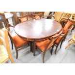 A mahogany extending dining table, and set of six chairs. The upholstery in this lot does not comply