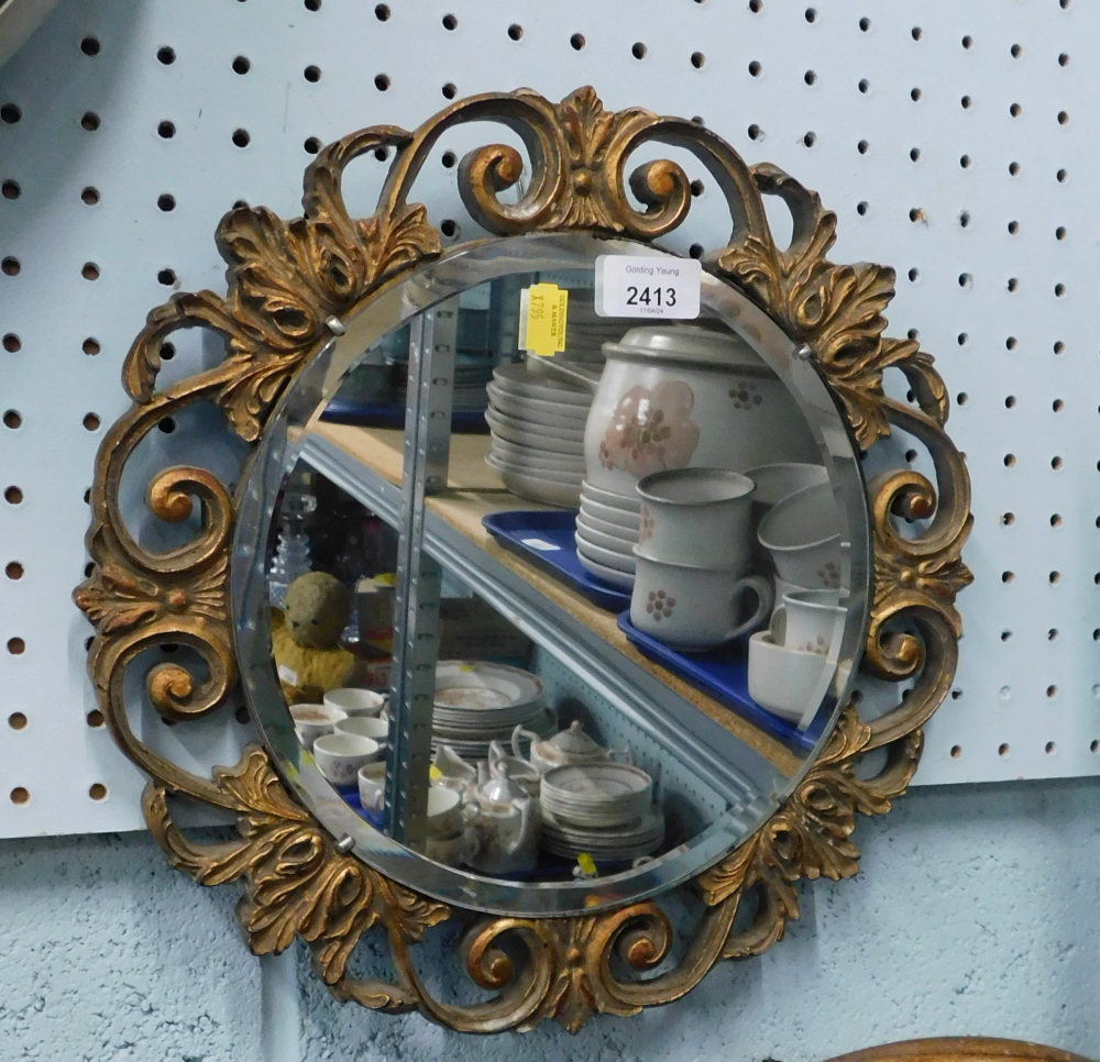 A circular gilt framed wall mirror.