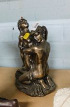 A composite resin figure group of a semi clad couple, with golden finish, 25cm high.