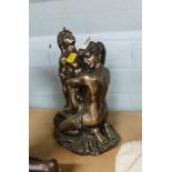 A composite resin figure group of a semi clad couple, with golden finish, 25cm high.