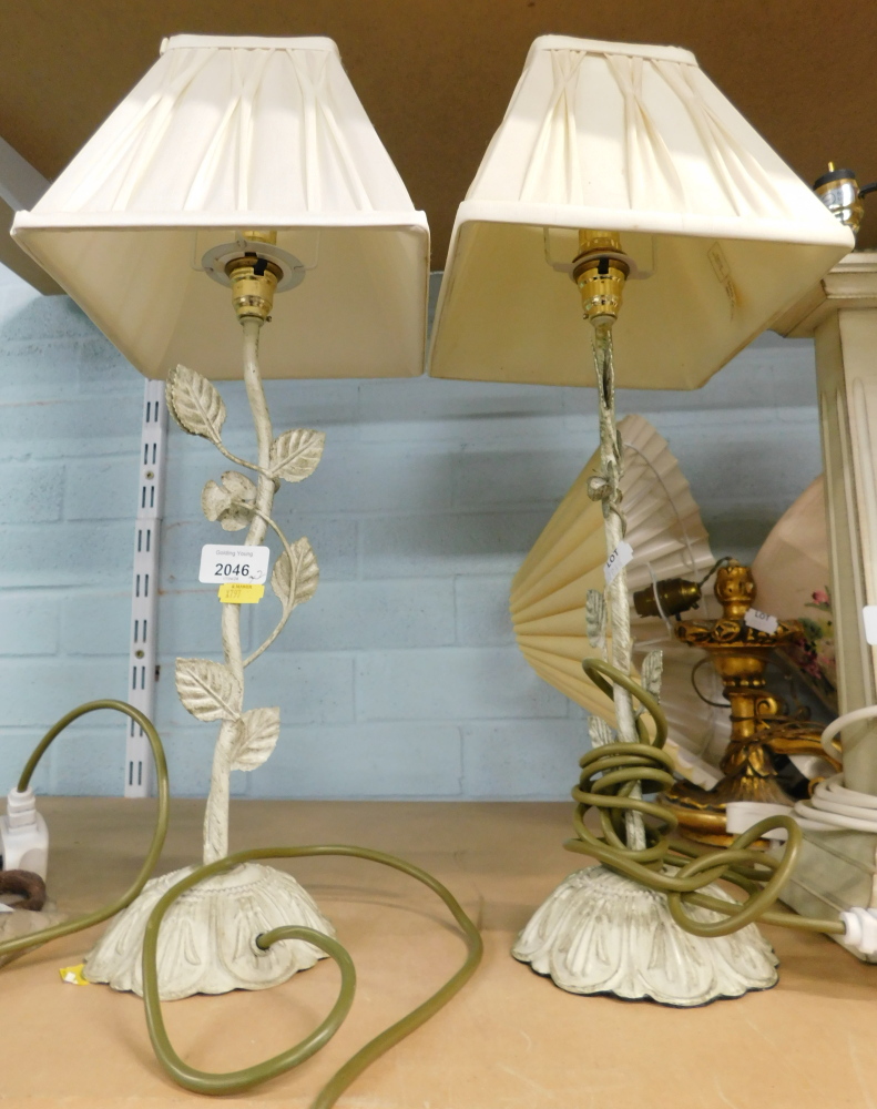 A pair of metal table lamps, each on twist stem with vine and flower decoration and cream square set