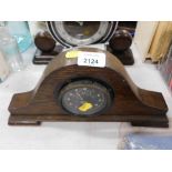 An oak cased mantel clock, with a Smiths MP car clock dial, 17cm high, 34cm wide.