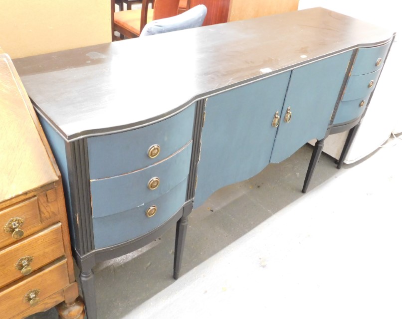 A painted sideboard, in two tone blue, with two cupboard doors flanked by three drawers to each side