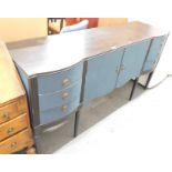 A painted sideboard, in two tone blue, with two cupboard doors flanked by three drawers to each side