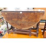 An 18thC oak drop leaf table.