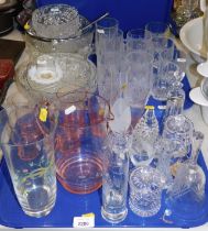 Glassware, comprising a pink 1950s glass lemonade jug and six beakers, drinking glasses, glass bell,