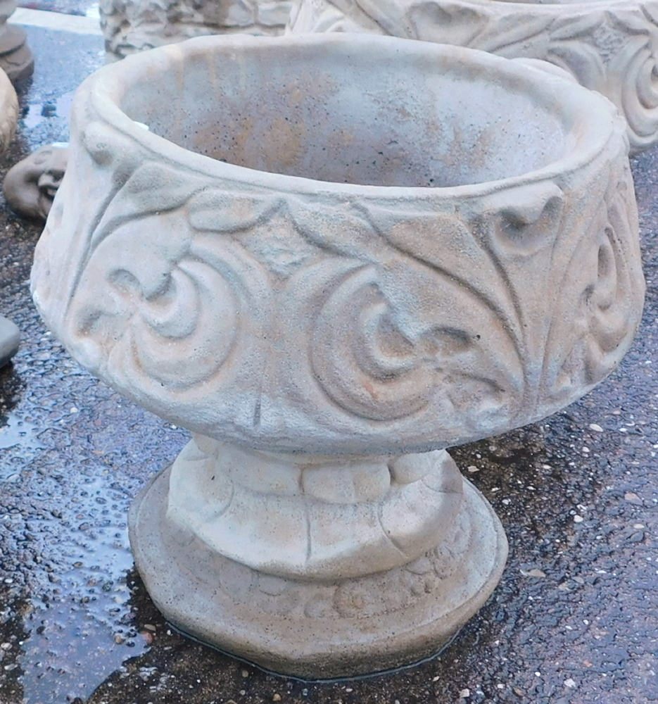 A reconstituted stone acanthus leaf garden urn, with a fluted border and shell Neoclassical scroll d