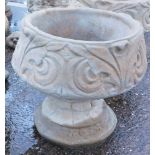 A reconstituted stone acanthus leaf garden urn, with a fluted border and shell Neoclassical scroll d