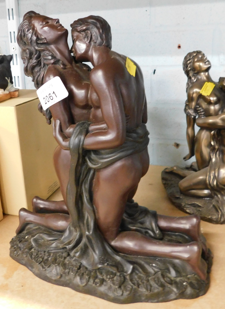 A composite resin figure group of a semi clad couple, in brown finish, 29cm high, 24cm wide.
