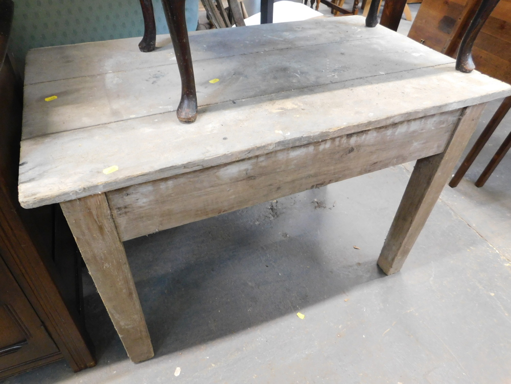 A pine kitchen table, with rectangular three plank top, 71cm high, 107cm wide, 61cm deep.