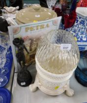 A white pierced finish jar and cover, a Petra advertising sign, stoneware jar and cover, and a repro