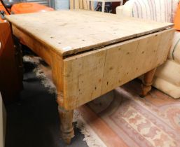 A Victorian stripped pine drop leaf kitchen table.