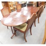 A reproduction mahogany twin pedestal dining table, with additional leaf and four cane backed chairs