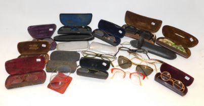 A group of 20thC cased spectacles, some in leather slipcases. (a quantity)