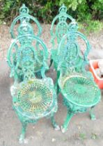 A set of four painted pierced metal garden chairs, each with scroll back.