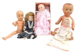 Collectors dolls, comprising a papier mache bodied child, porcelain headed baby, 1960s doll in black
