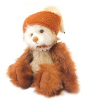 A Charlie Bears Teddy bear, ginger and white fur with hat, bearing label, 33cm high.