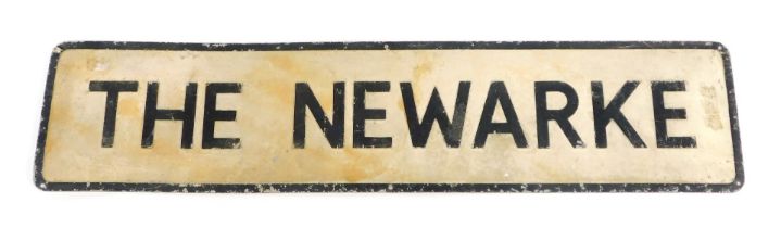 A metal street sign titled The Newarke, on cream and black painted border, 23cm high, 101cm wide.