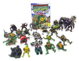 A collection of Teenage Mutant Ninja Turtle figures, Annual for 2006, weapons, etc. (1 box)