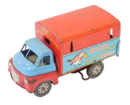 A Japanese tinplate clockwork truck, in blue and red, with Robin paint and poster advertising.